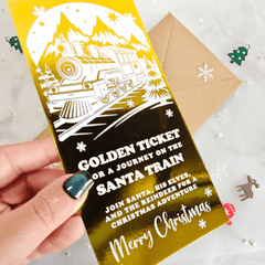 Invitation card for a journey on the Santa Train with a hand holding it.