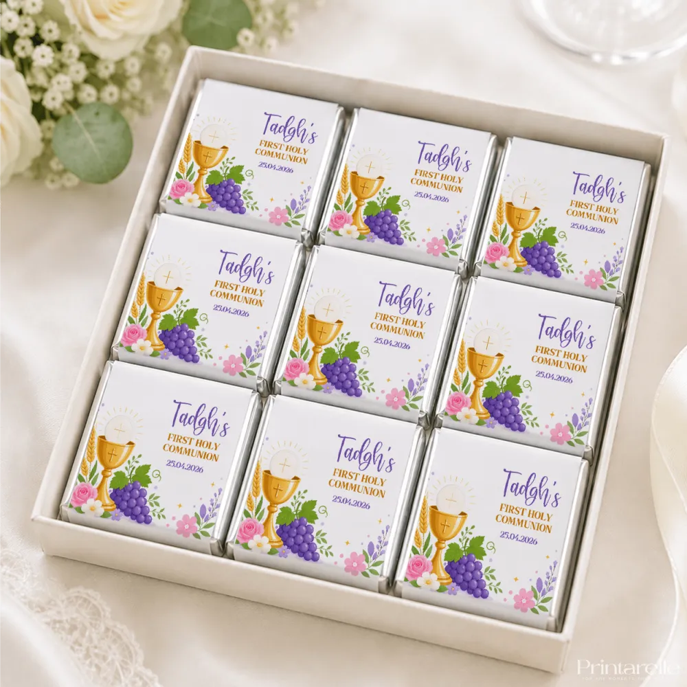 White chocolate mini neapolitan chocolates with gold foil and decorative paper featuring a golden chalice and grapes