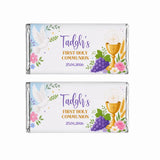 Two personalised 40g chocolate bars wrapped in silver foil with white labels and purple gold text for holy communion