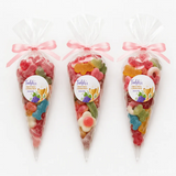 Three sizes of clear cellophane communion sweet cones filled with colorful gummy candies and pink ribbons