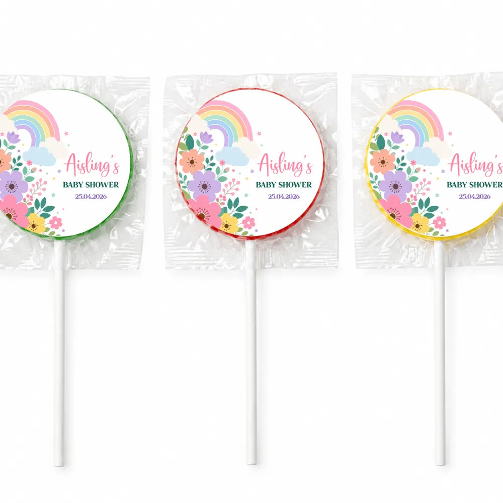 Three colorful swirl lollipops finished with pastel rainbow and floral designs for baby shower favours