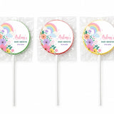 Three colorful swirl lollipops finished with pastel rainbow and floral designs for baby shower favours