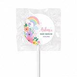 A colorful floral pastel rainbow swirl lollipop finished with a white stick wrapped in clear plastic for baby shower