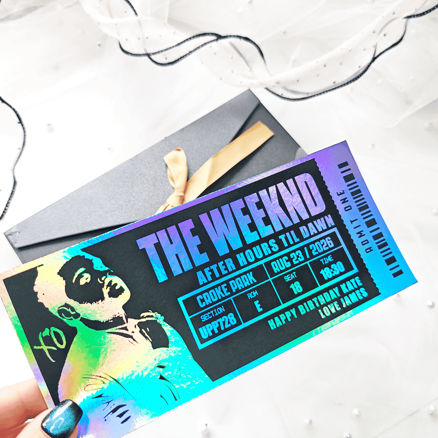 Holographic concert ticket for The Weeknd with colorful design and text.