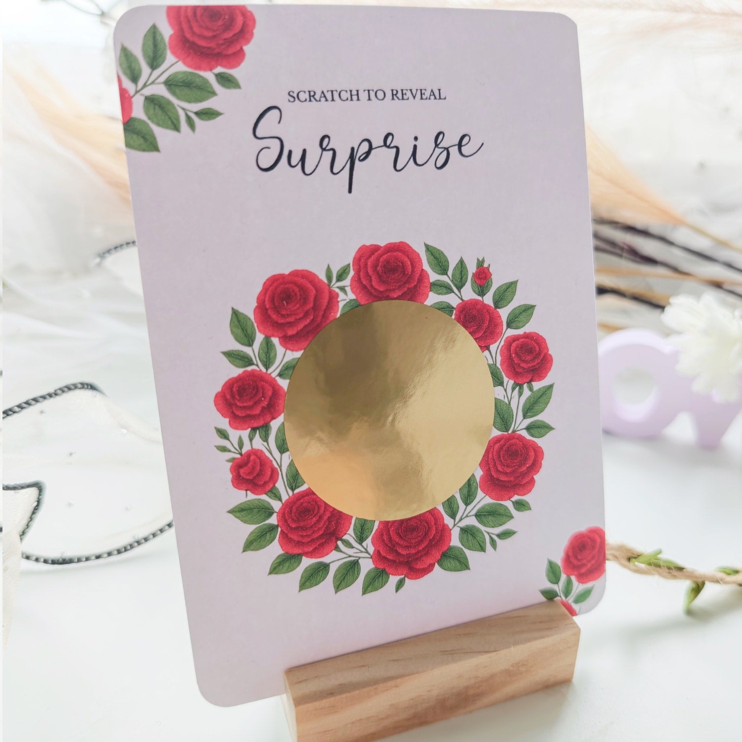 Gold scratch-off circle on rose design card