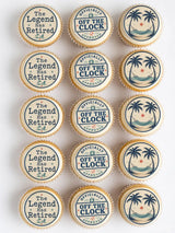 Retirement edible cupcake toppers with white frosting navy blue printed designs and tropical beach scenes
