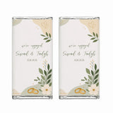 Two personalised 40g chocolate bars wrapped in white paper with beige green and gold floral heart designs