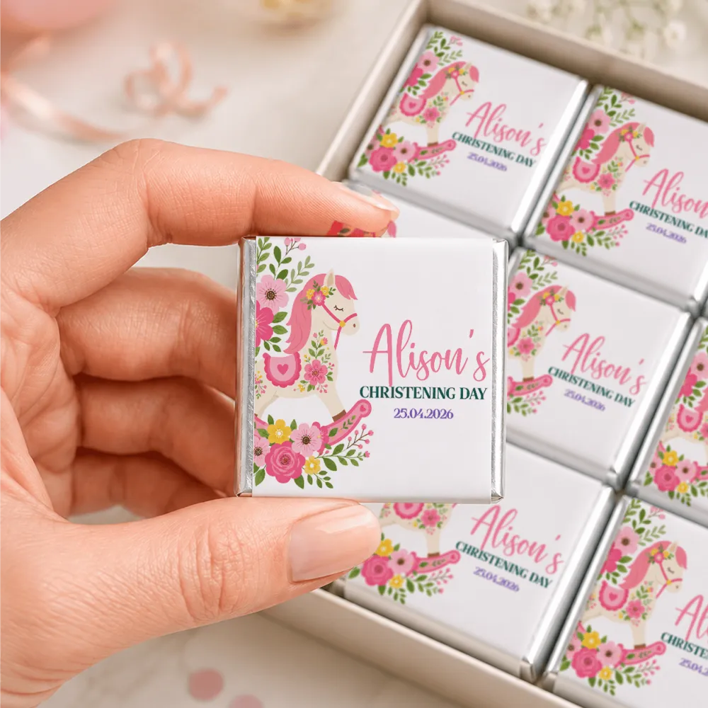 A pink and white floral rocking horse mini neapolitan chocolates bar wrapped in silver foil for christening gifts