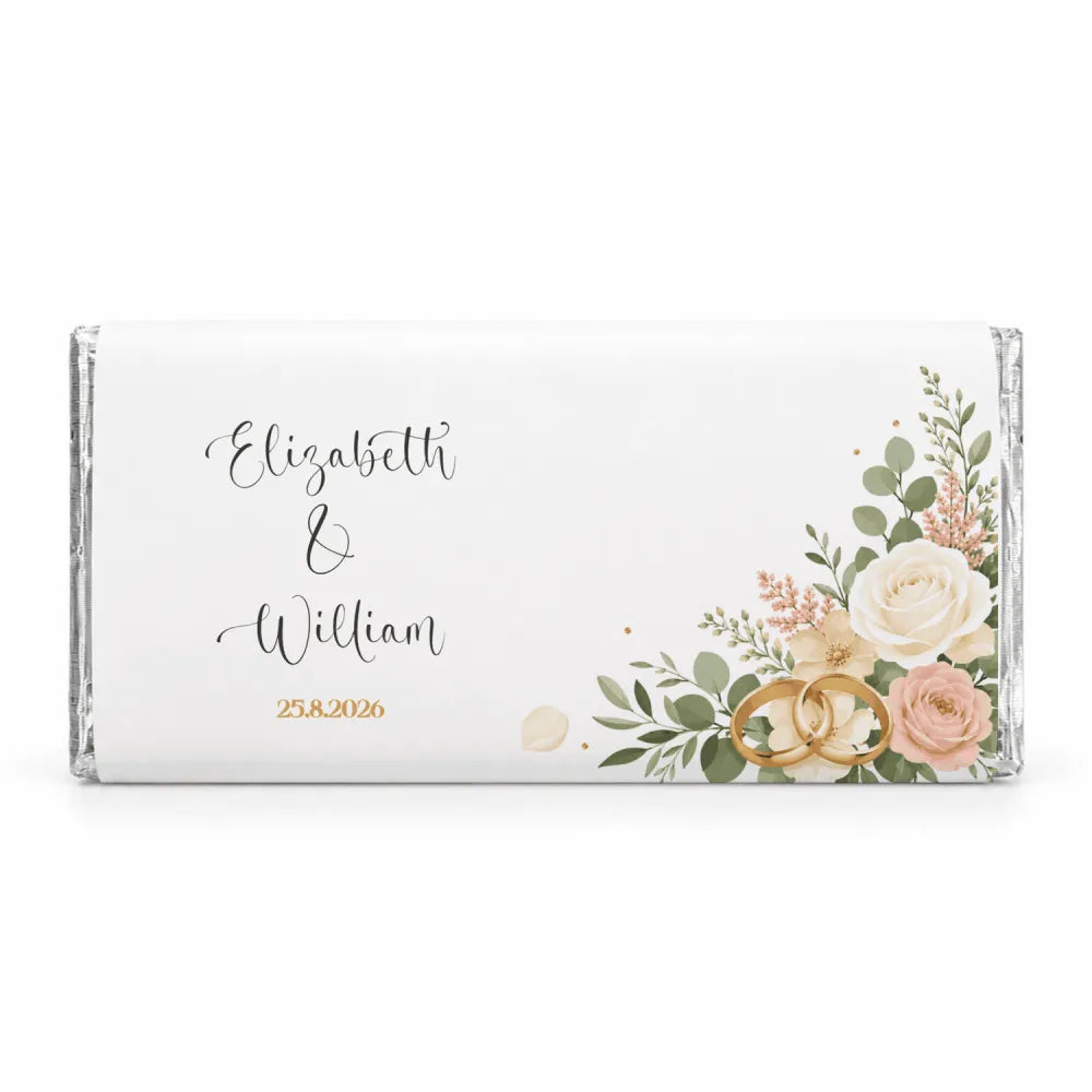 A personalised 40g white chocolate bar wrapped in clear foil with blush rose floral design and two gold wedding rings