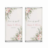 Two personalised 40g chocolate bars with soft pink and green floral design wrapped in clear foil for rose corner wedding