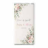 A delicate personalised 40g chocolate bar wrapped in clear foil with cream paper and pink rose design for weddings