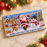 A festive gold-wrapped chocolate bar wrap with santa reindeer and snowman for family christmas fun