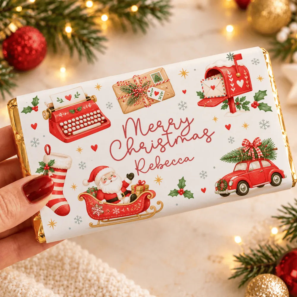 A personalized white chocolate bar wrapped in festive red and gold foil with santa sleigh, retro typewriter, and mailbox design