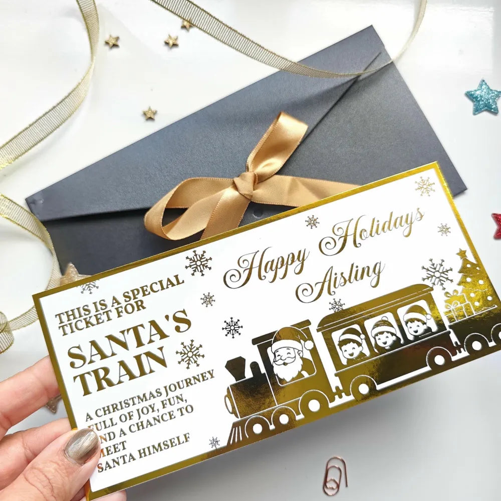 Gold foil santa train keepsake card with festive snowflakes and happy holidays aisling text for christmas surprise reveal
