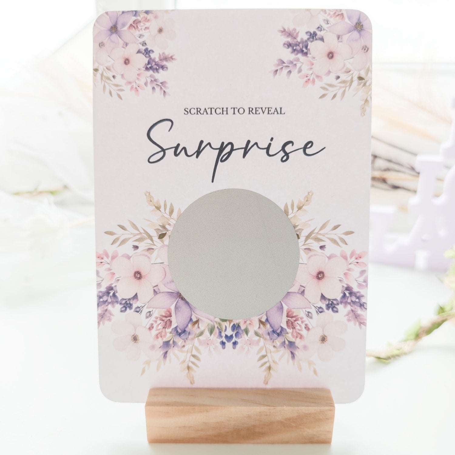 Personalised scratch-to-reveal surprise card with floral design and hidden message for travel, pregnancy, or proposal.