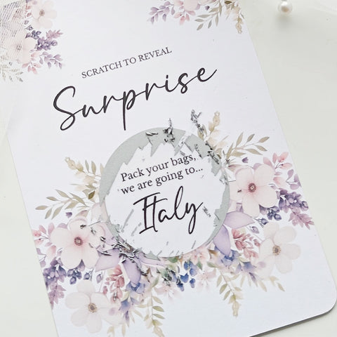 Personalised scratch-to-reveal surprise card with floral design and hidden message for travel, pregnancy, or proposal.