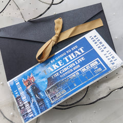 Gift box with a blue ticket-style design featuring circus elements on a textured surface.
