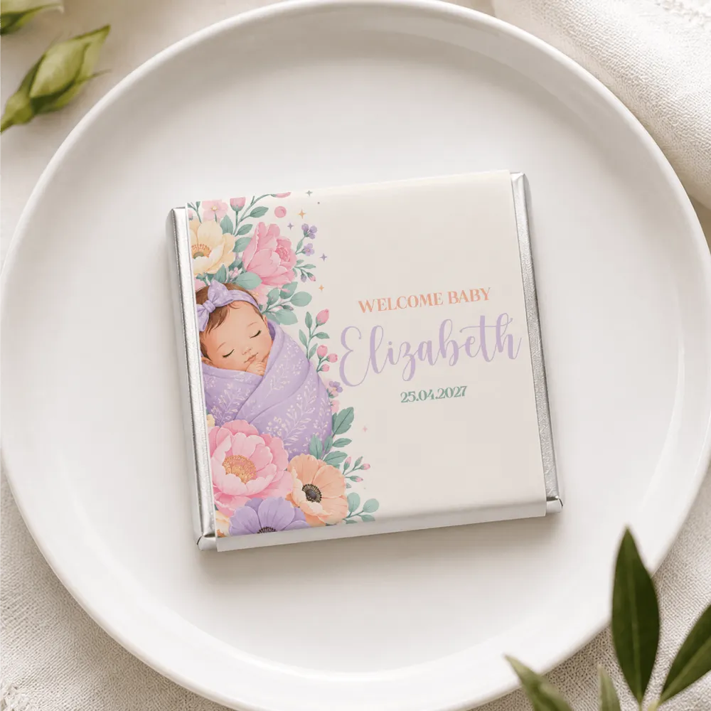 A personalized mini neapolitan chocolate bar wrapped in silver foil with a sleeping baby and floral design