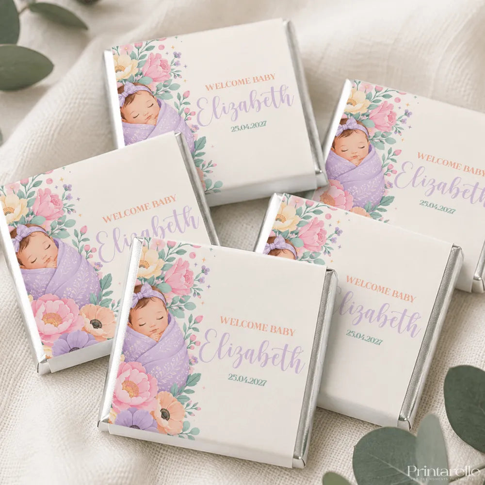 Pastel purple and pink floral mini neapolitan chocolates wrapped in silver foil with a sleeping baby girl illustration