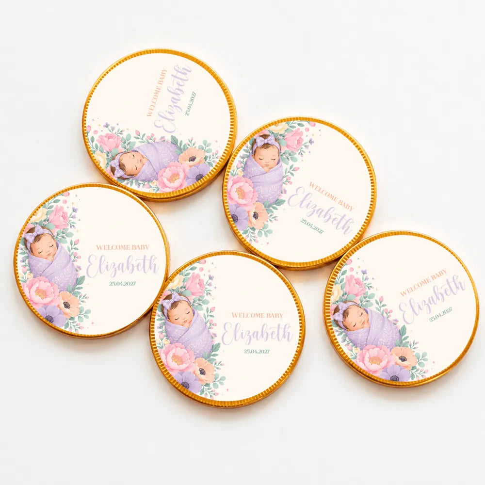 Round gold-edged 40mm milk chocolate coins with a sleeping baby wrapped in lavender surrounded by pink flowers