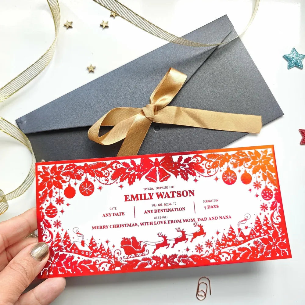 Red and white christmas holiday reveal card with intricate cut-out ornaments sleighs and trees for festive surprise