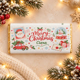 A personalized white chocolate bar with cocoa butter and gold foil edges featuring festive christmas snow globe illustrations