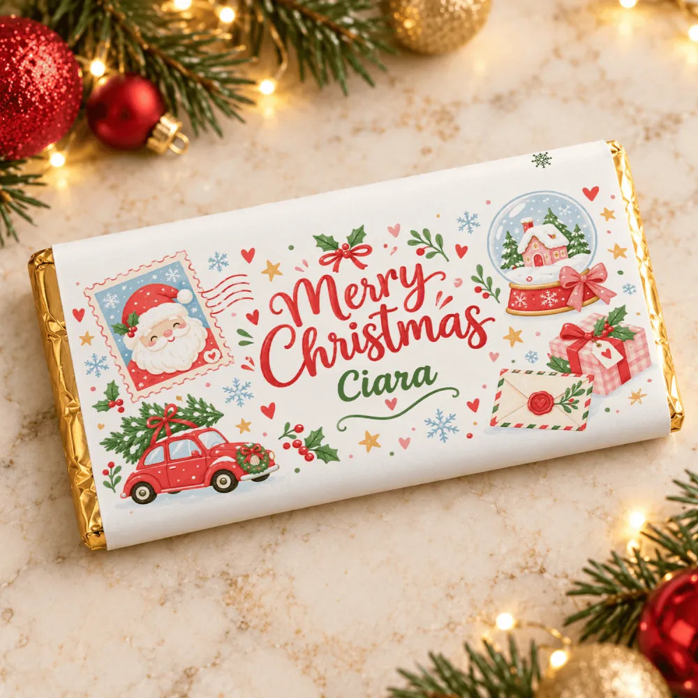 A festive white chocolate bar wrapped in gold foil with santa snow globe and red cars design for christmas gift
