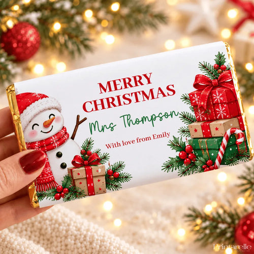A festive white christmas chocolate bar wrapped in gold foil with a snowman and christmas gift chocolate bar wrap