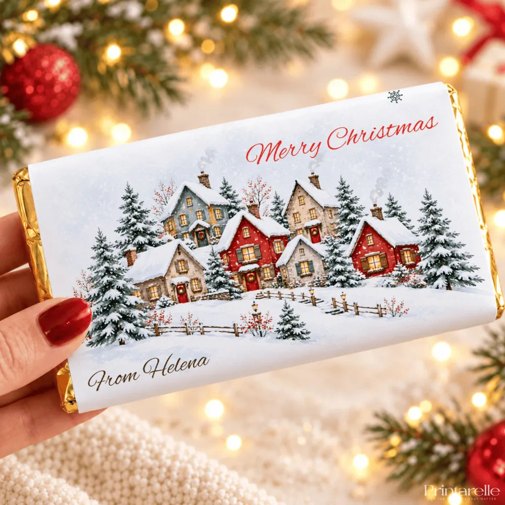 A festive white christmas chocolate bar with a personalised christmas chocolate wrap featuring snowy cottages and pine trees