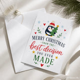 A festive white penguin christmas card with a red hat and small green tree titled still your best decision
