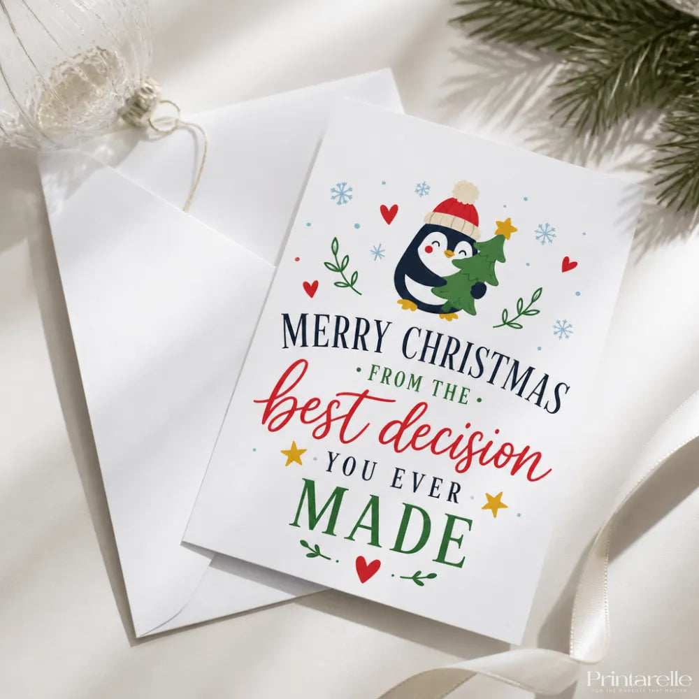 A festive white penguin christmas card with a red hat and small green tree titled still your best decision