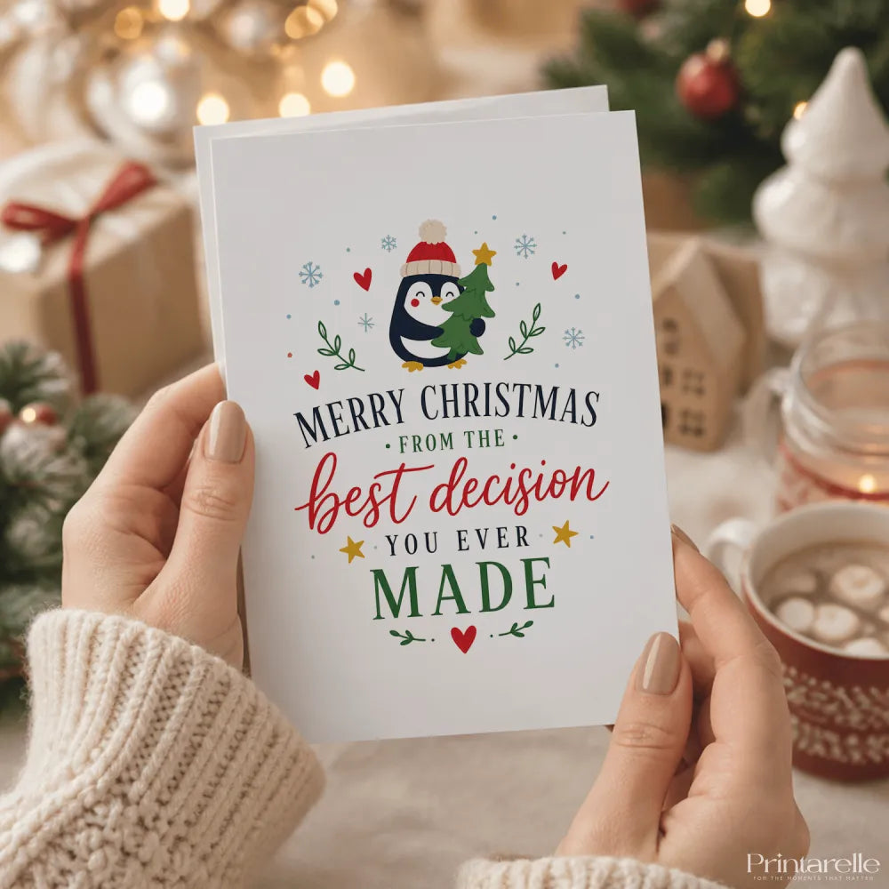 A white penguin christmas card with a red hat holding a green tree and the text merry christmas best decision