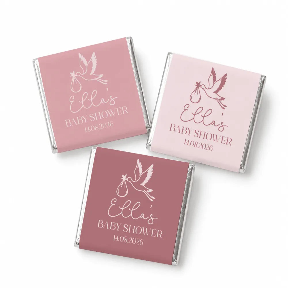Pink and mauve mini neapolitan chocolates wrapped with white stork design for ellas baby shower favors