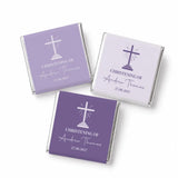 Purple and white mini neapolitan chocolates wrapped in silver foil with a cross design for christening favours