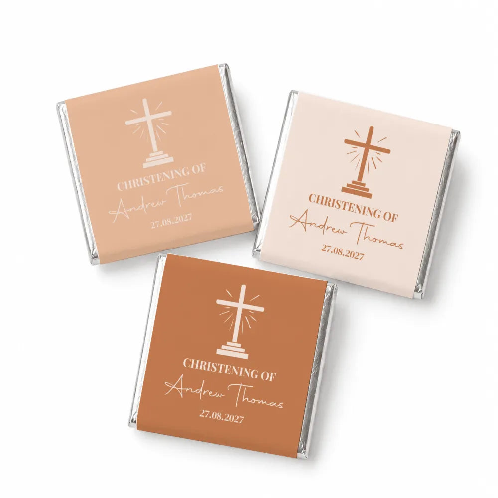 Three mini neapolitan chocolates with cross design wrapped in matte beige and terracotta foil for christening favors