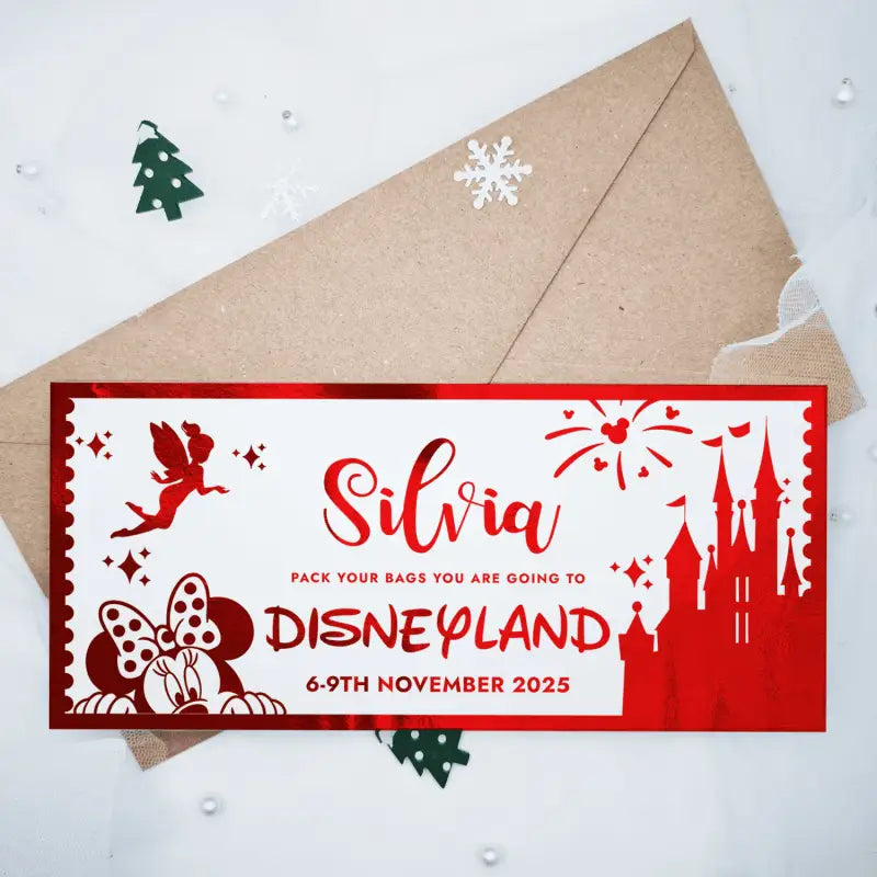 Invitation card to Disneyland with castle and fairy design, placed on a white background with decorative elements.