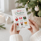 A white girlfriend christmas card with colorful festive illustrations held in hands against a holiday background