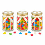 Three personalised 106ml glass jars with 48mm pale gold lids and cream bows filled with colorful jelly beans for party favours