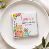 A white chocolate bar in a colorful floral wrapper with teddy bear design from teddy garden mini neapolitan chocolates