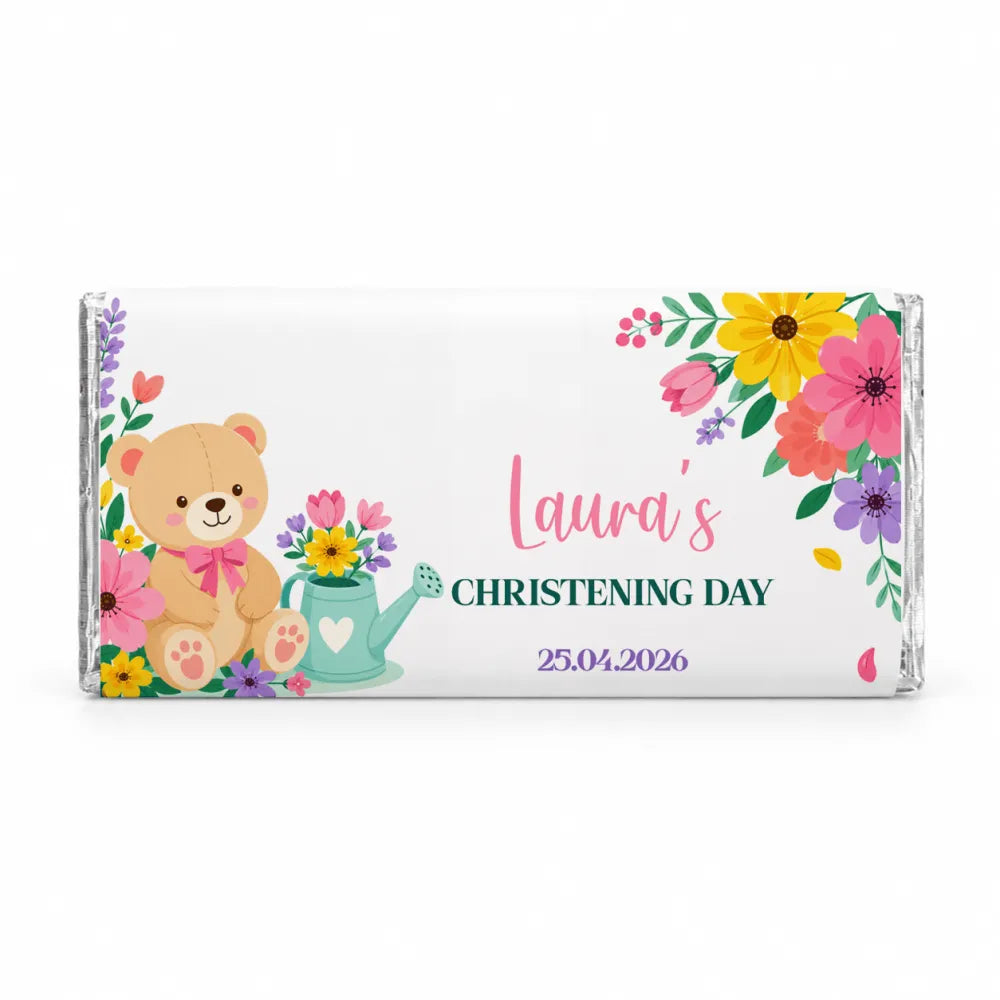 A white 40g chocolate bar wrapped in clear foil with a teddy bear and floral design for lauras christening day