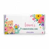 A white 40g chocolate bar wrapped in clear foil with a teddy bear and floral design for lauras christening day