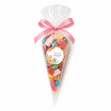 A clear plastic sweet cone filled with colorful gummies tied with a pink ribbon and a teddy bear garden label