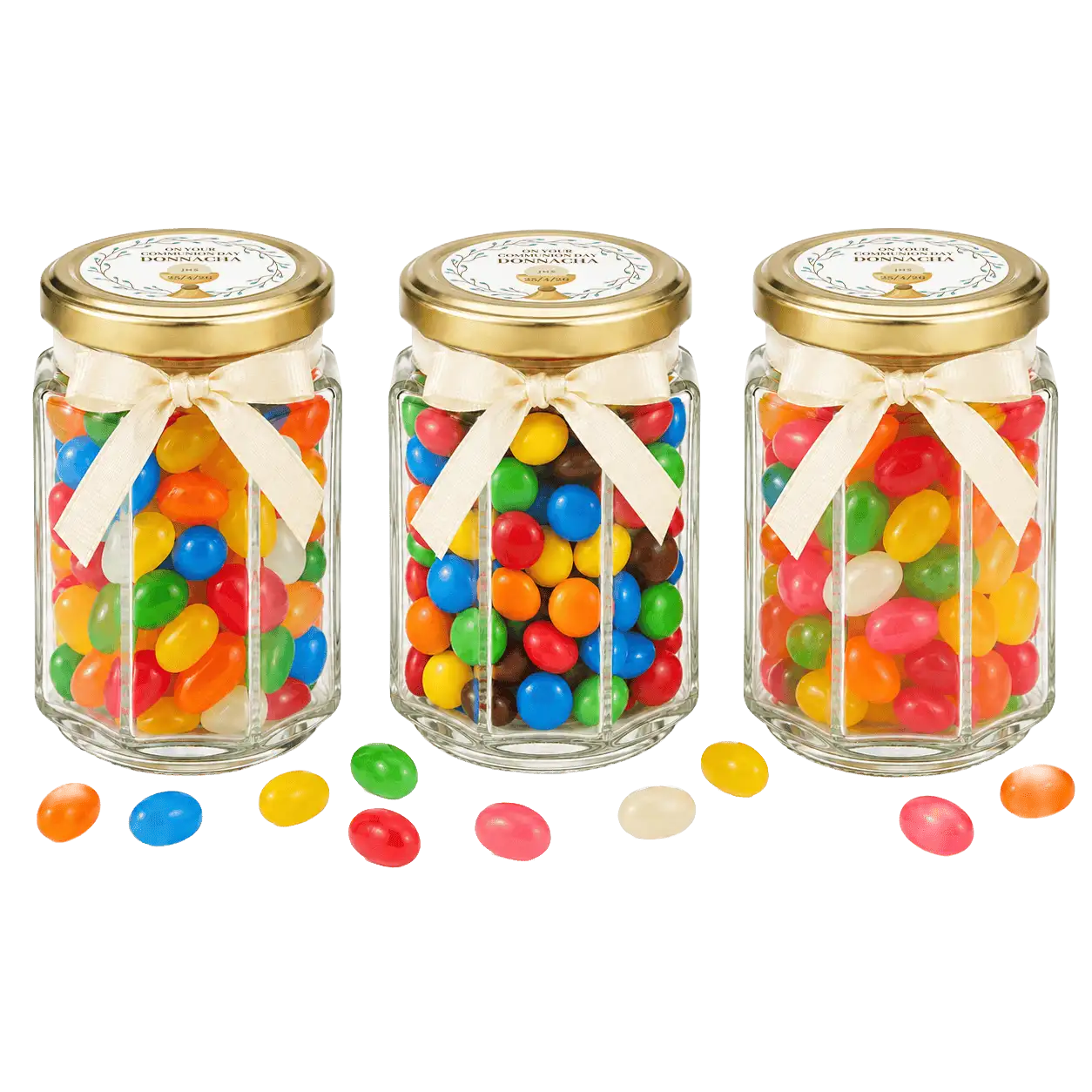 Three clear glass jars with gold lids and cream-colored ribbons, each filled with colorful jelly beans.