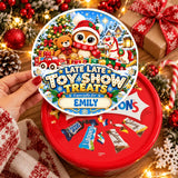 A festive red circular tub sticker for toy show elf owl treats featuring an owl bear horse and candy cane design