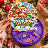 A festive purple circular tin with a personalised tub sticker for emily featuring toy train and candy cane illustrations