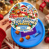 Blue cadbury roses tub sticker featuring festive owl, teddy bear, and horse in christmas attire with candy cane and toy train design