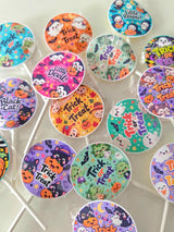 Colorful halloween-themed assorted fruit lollipops with black cat and cartoon characters on glossy wrappers
