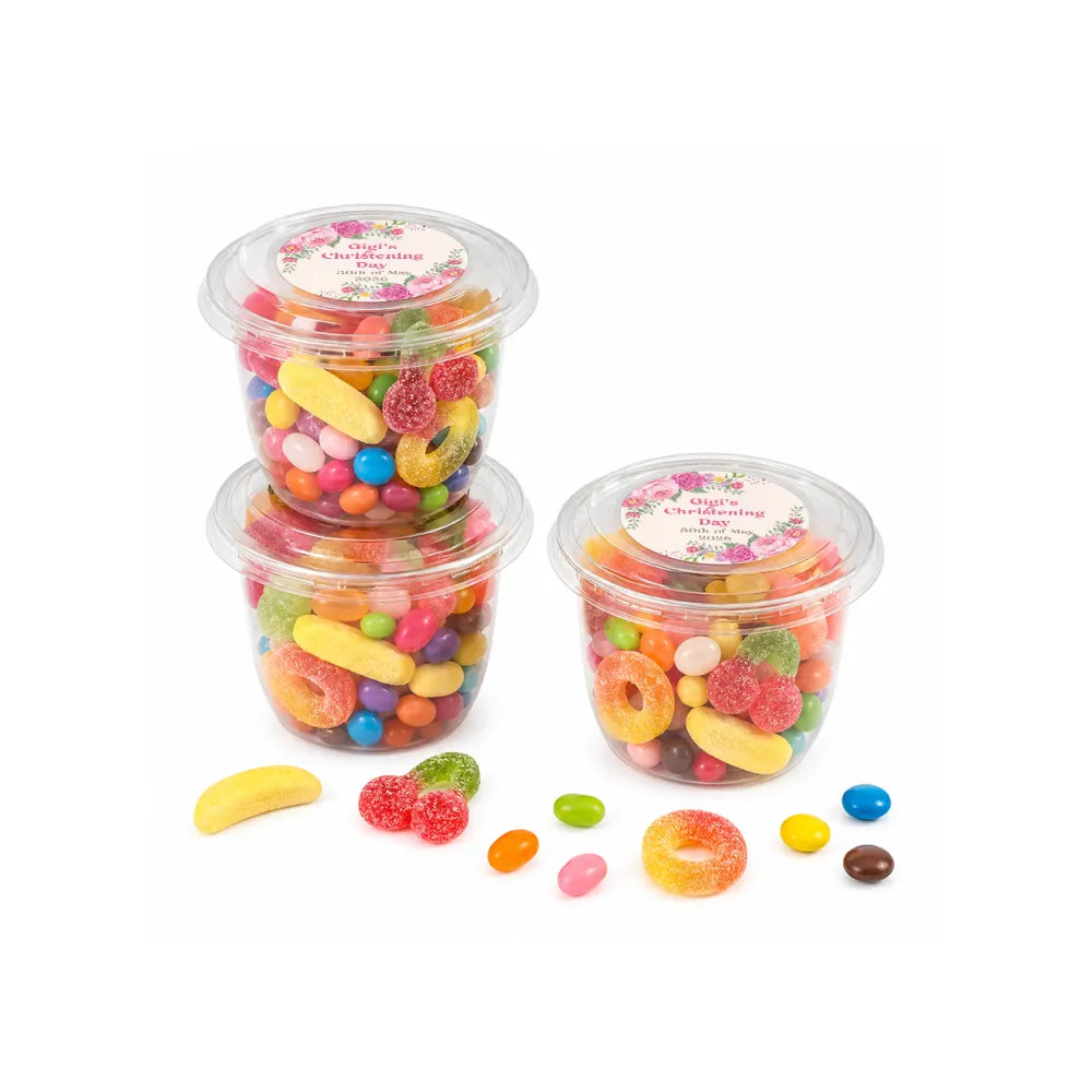 Clear plastic sweet tub with snap-on lid filled with colorful gummy candies party favours for girls christening day