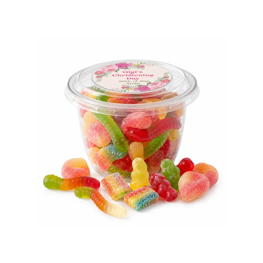 A clear plastic sweet tub with snap-on lid filled with colorful sugar-coated gummy party favours in various shapes