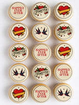 Vintage tattoo style wedding cupcake toppers with red hearts swallow birds and forever text on cream frosting wedding cupcake